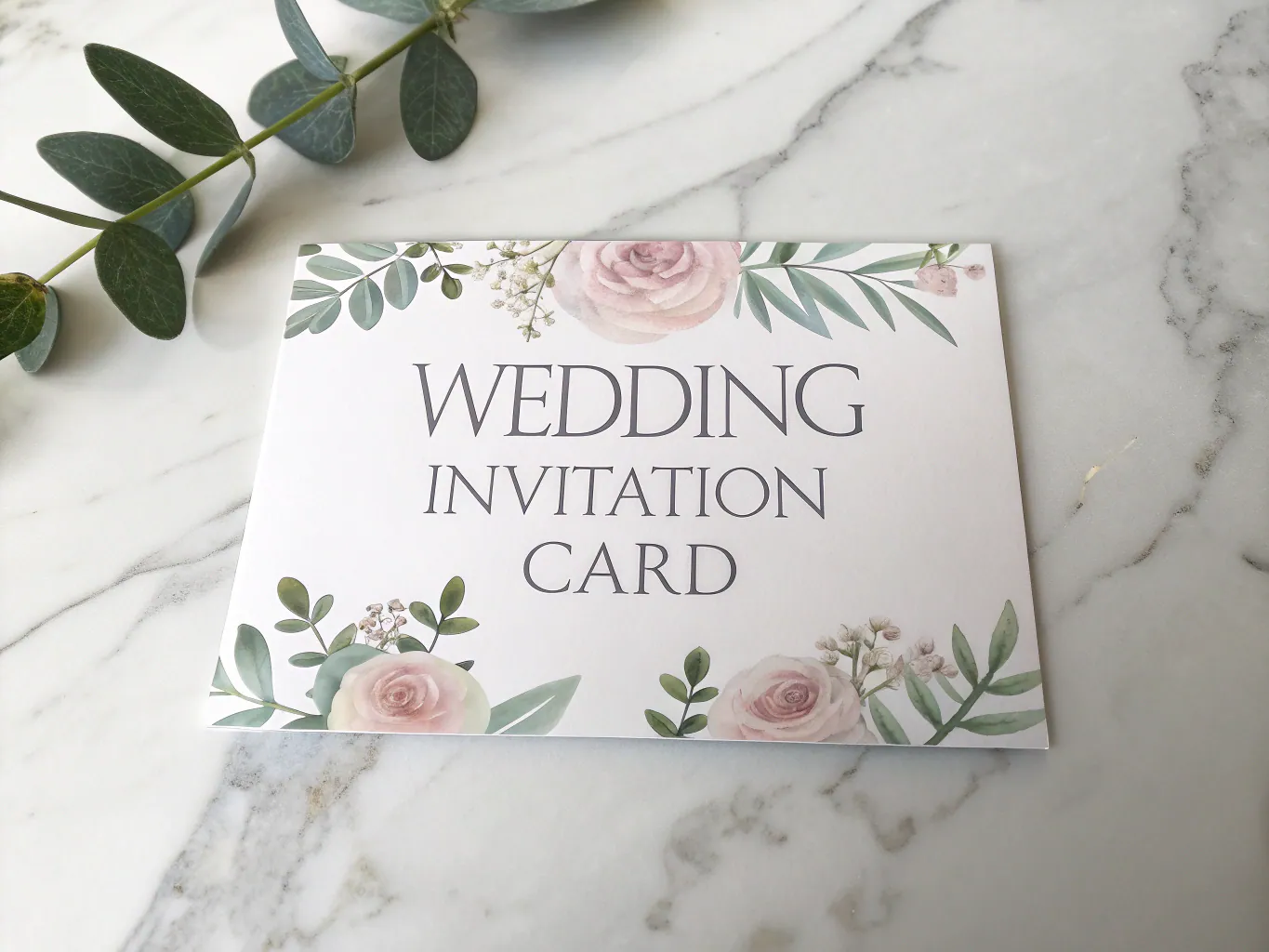 Intricately engraved wedding invitation and table decor